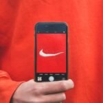 person holding iPhone taking picture on Nike label